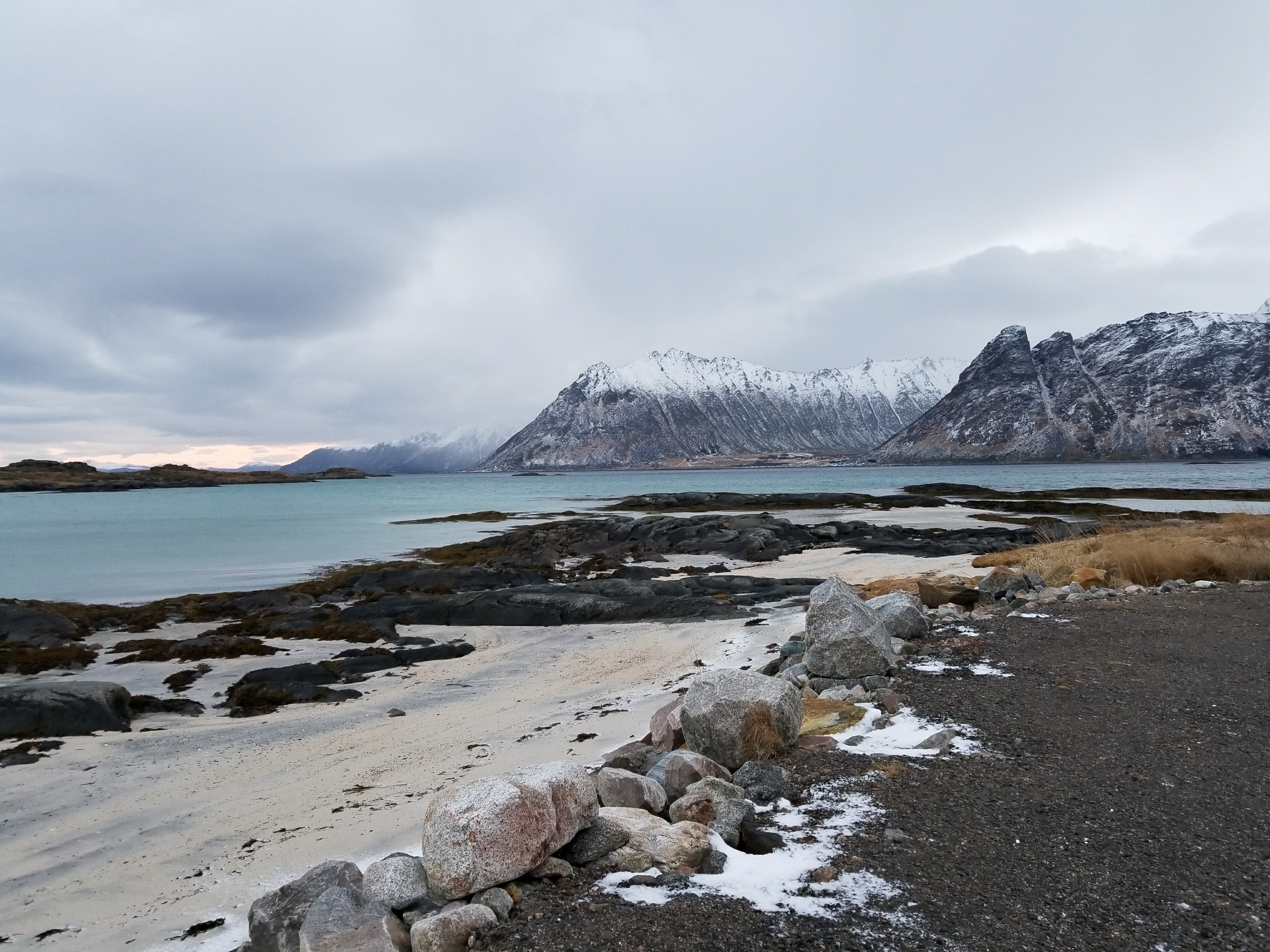 Crystal clear lakes surrounded by snowcapped mountains in Lofoten Islands
