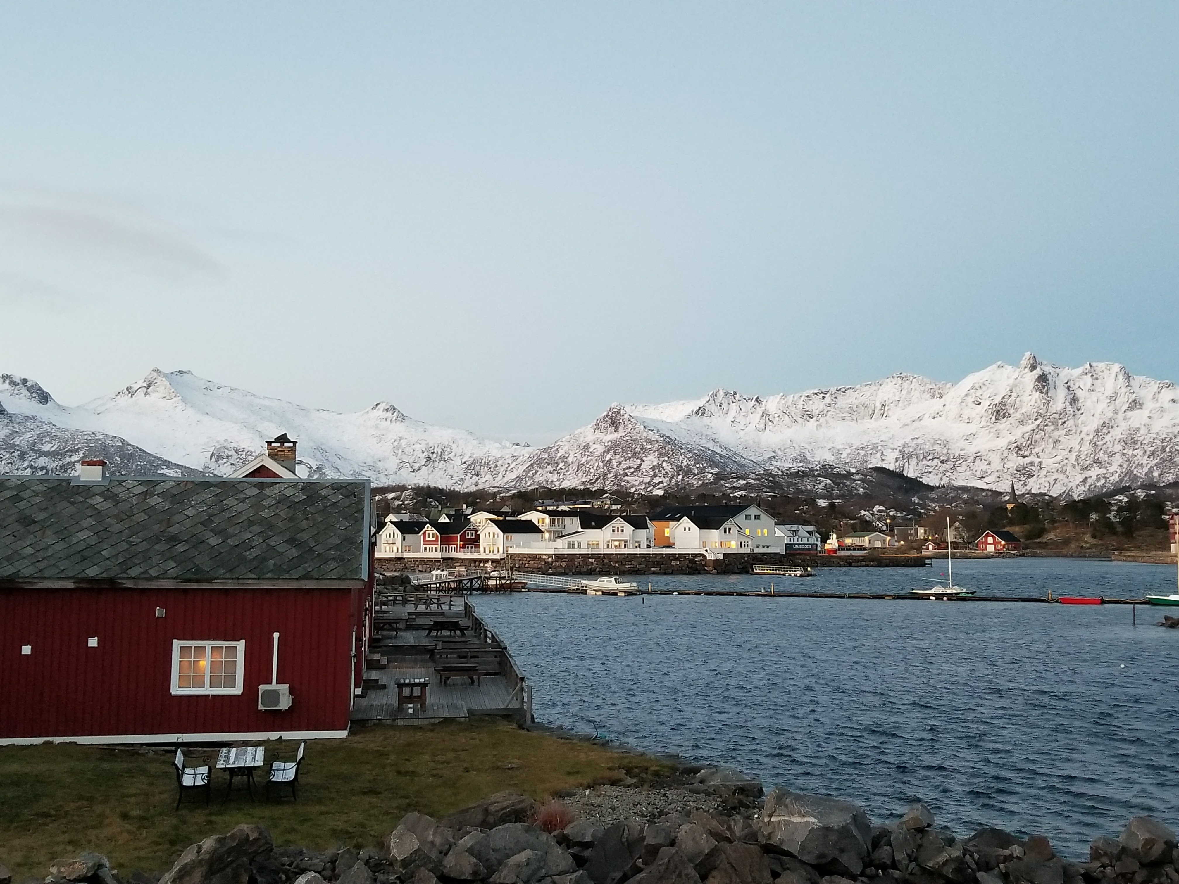 Small fishing village in the Lofoten islands surrounded by snow-capped mountains