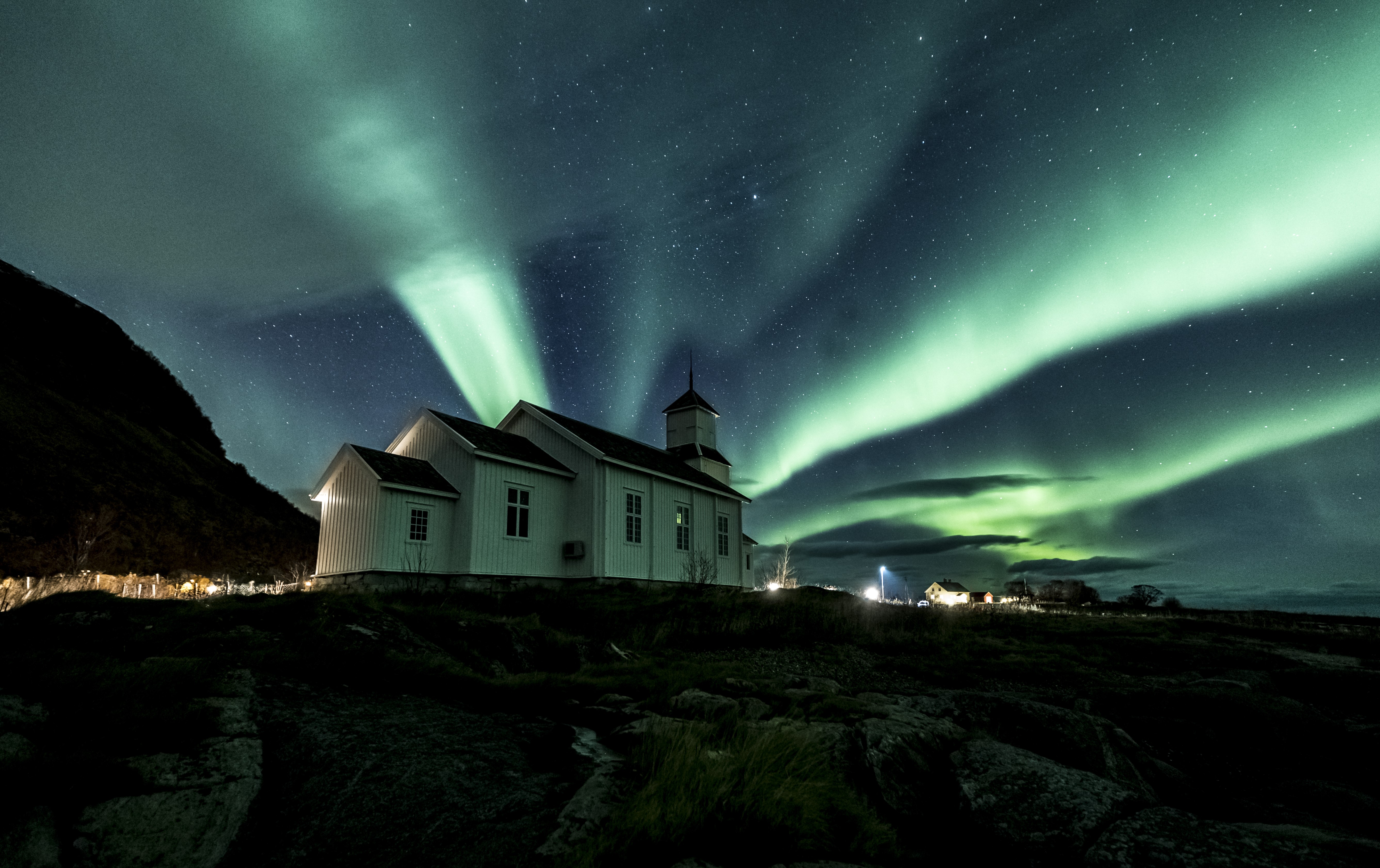 The Northern Lights dancing above a church in Norway