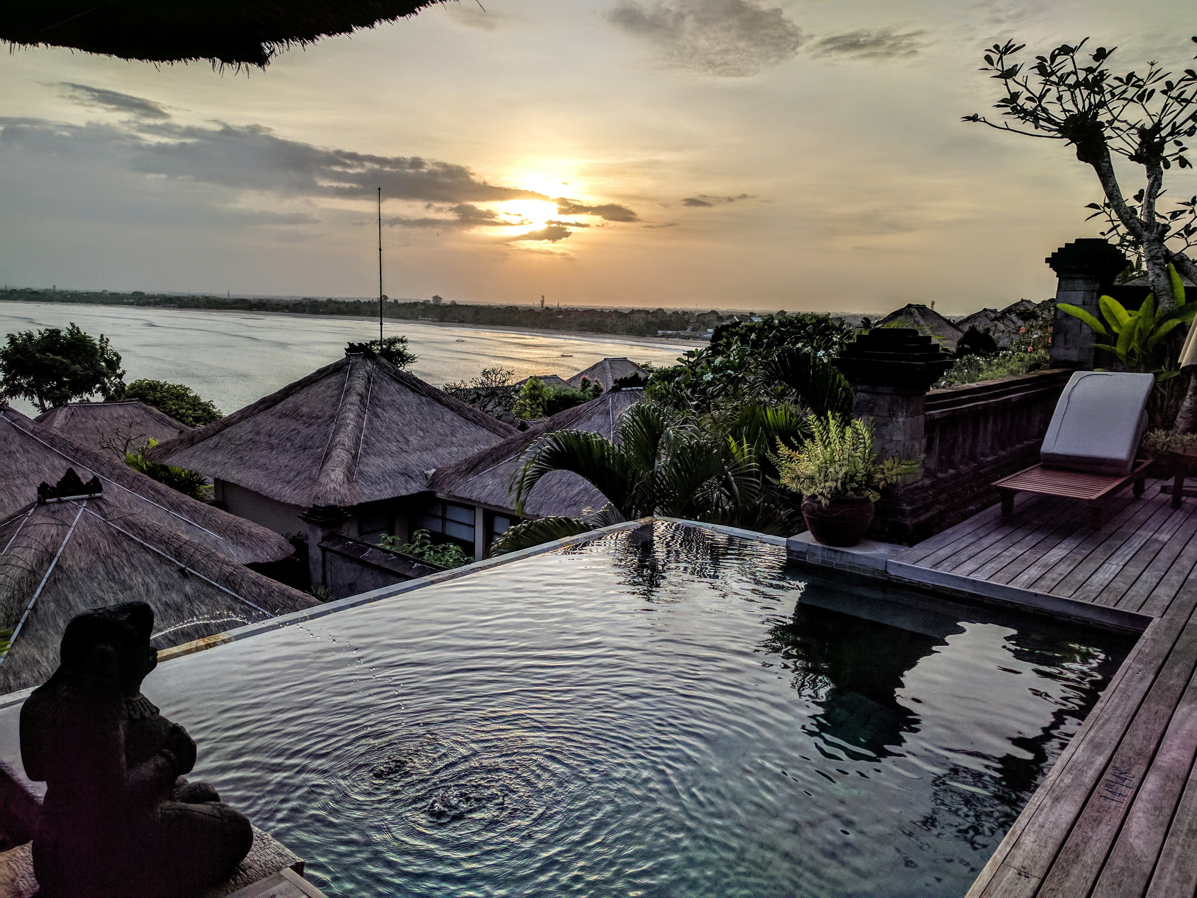 Infinity pool villa at sunset overlooking the Indian Ocean in Bali. Four Seasons Jimbaran Bay